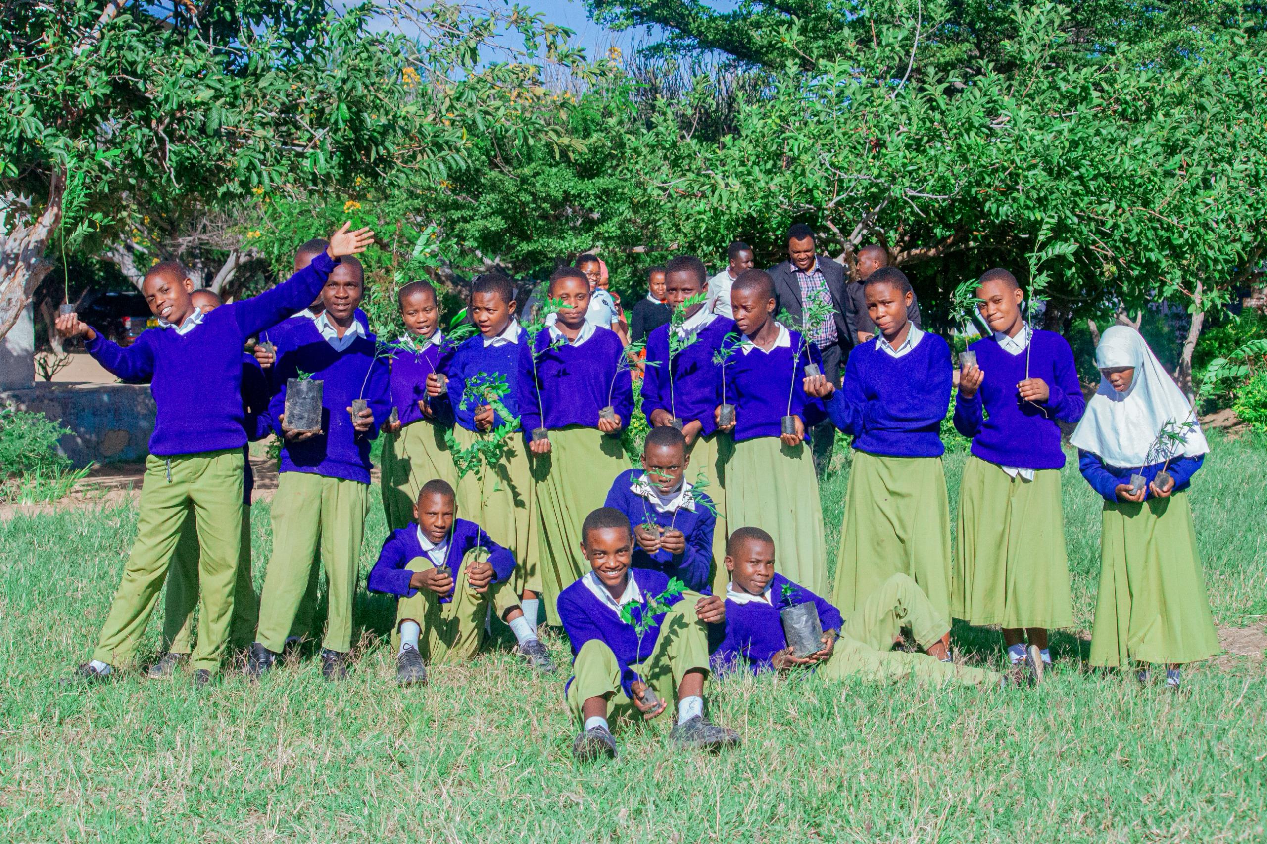 Young people working together to plant a tree